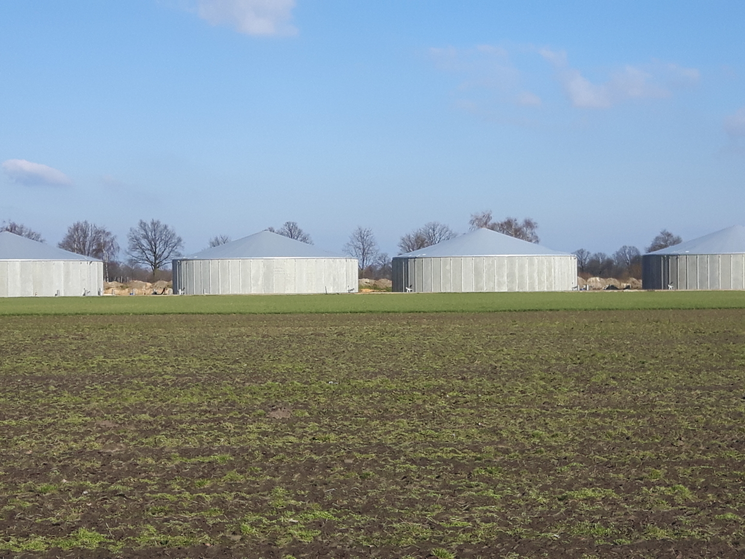 Four concrete silos with tensioned covers