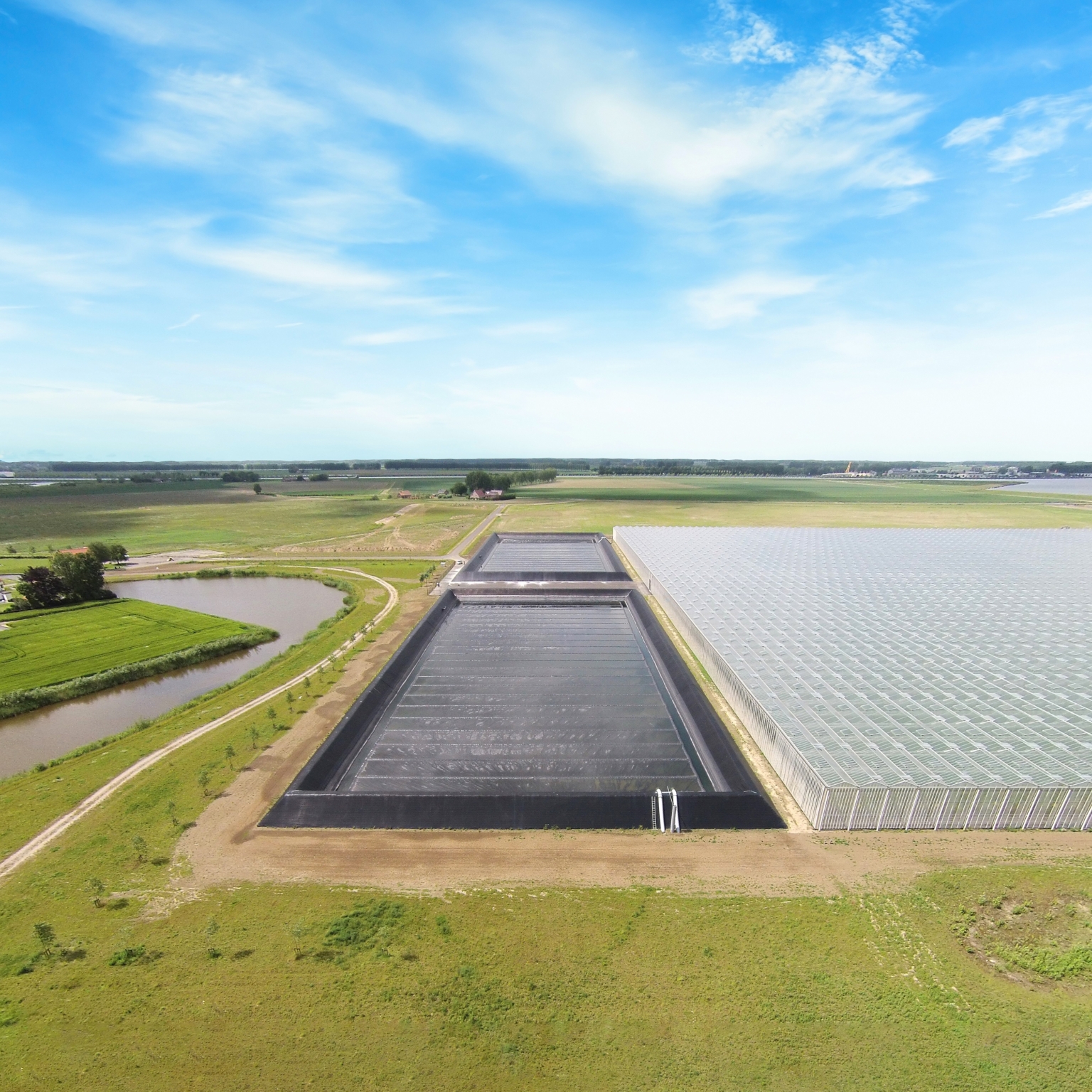 Drone photo of two semi-closed Genafloats in a water reservoir