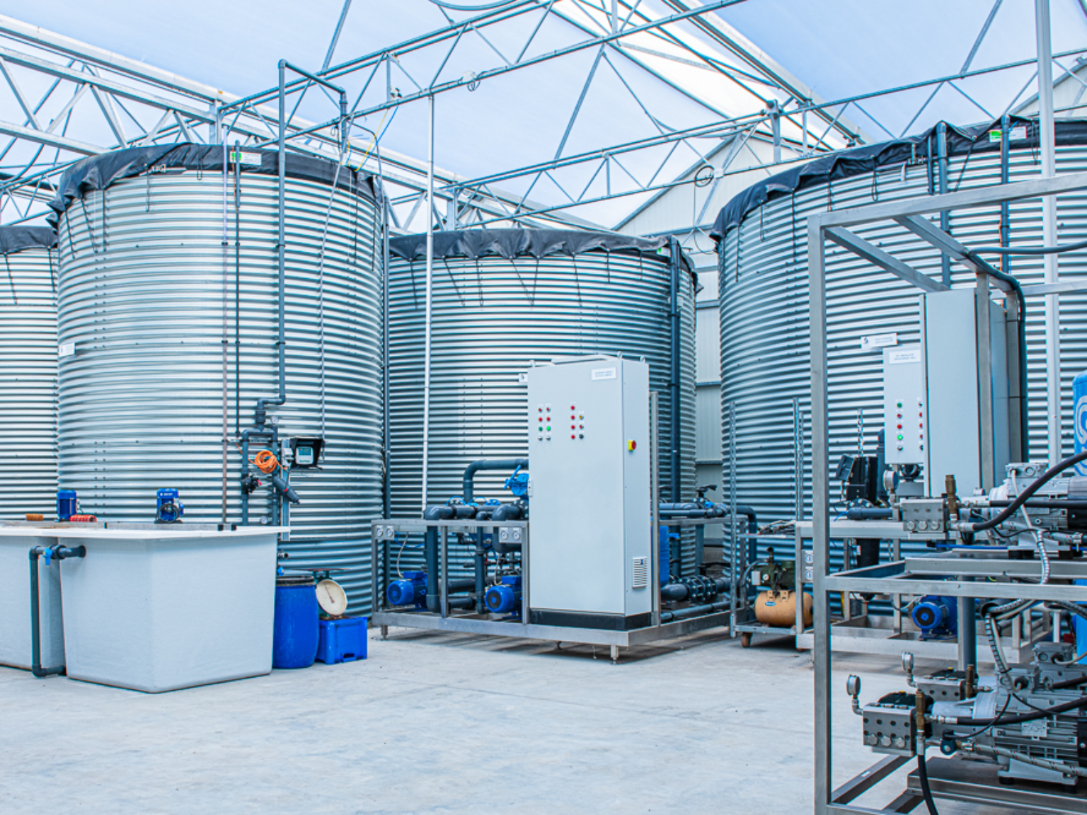 Water tanks installed indoors with pump equipment