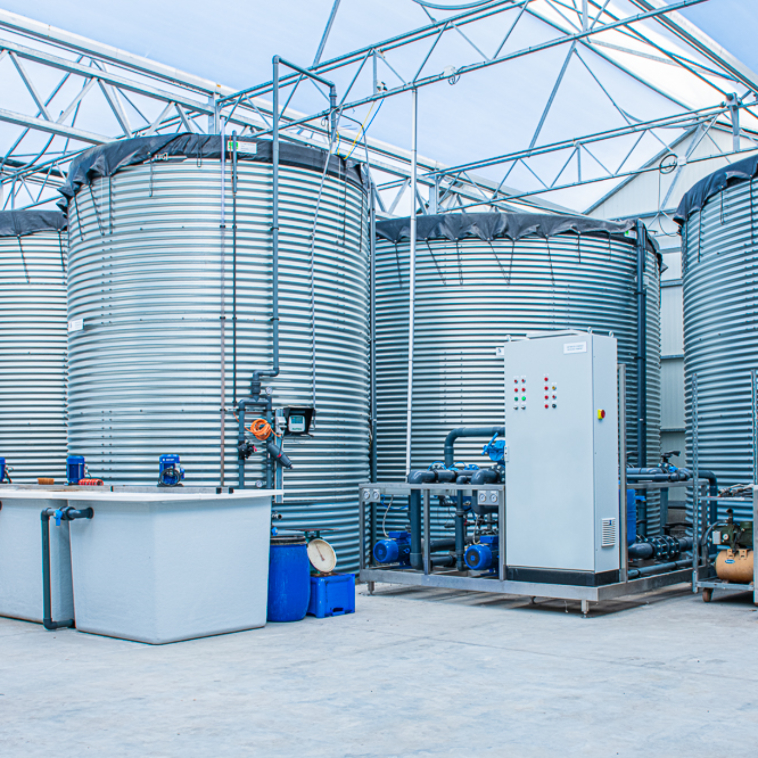 Water tanks installed indoors with pump equipment