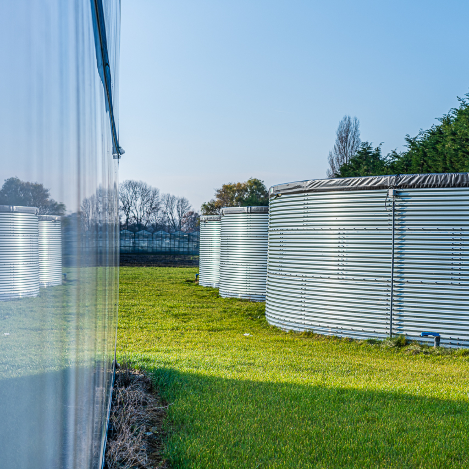 Three water tanks installed outdoors