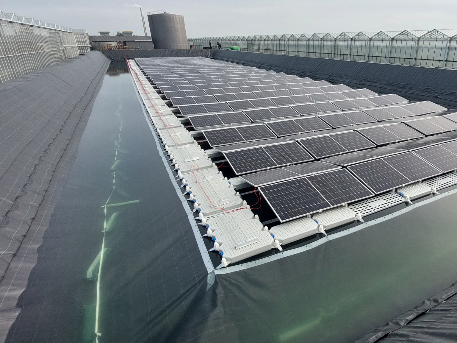 Attachment of the sun-on-water solar panels to the bank protection of a water reservoir