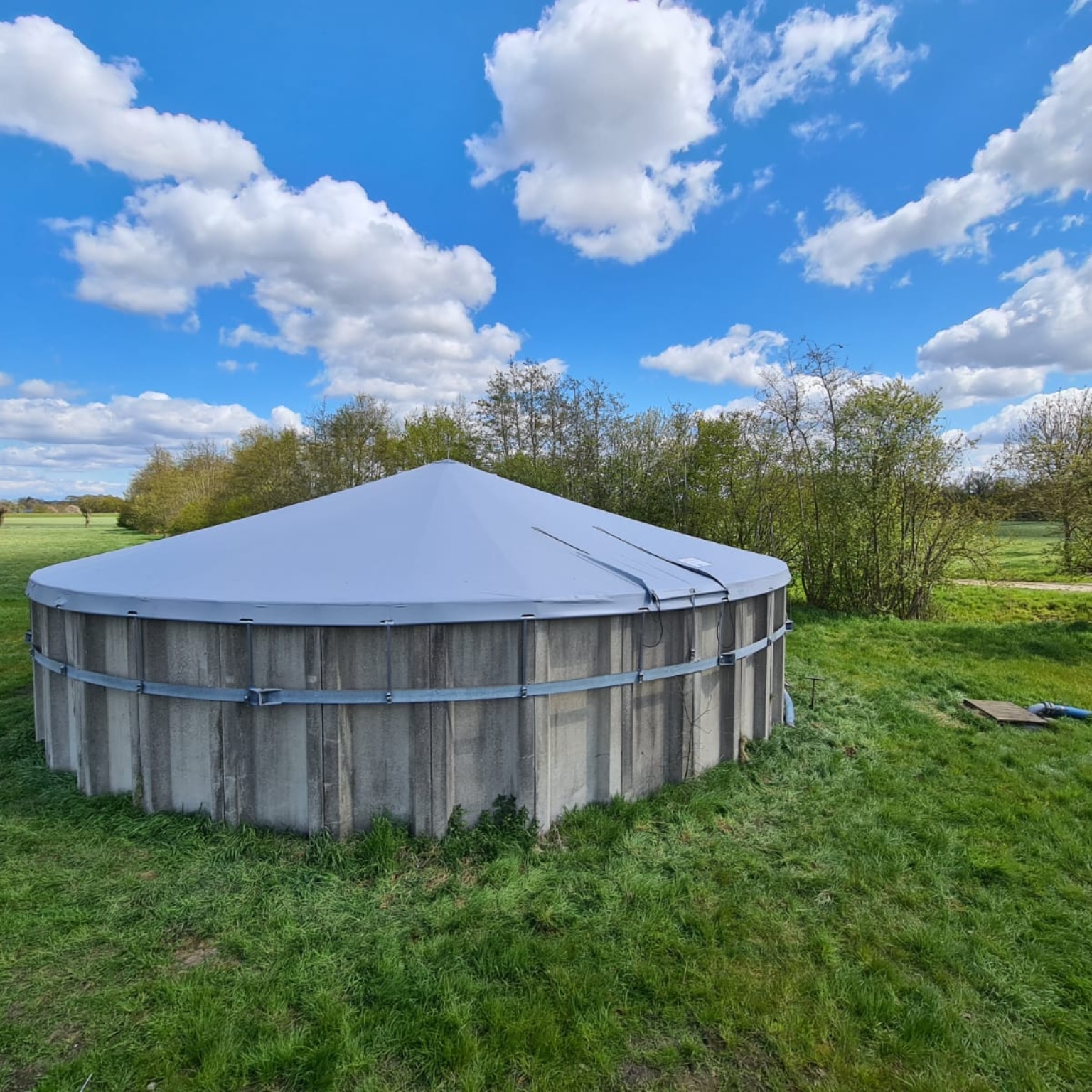 Tensioned cover on concrete slurry silo viewed from above